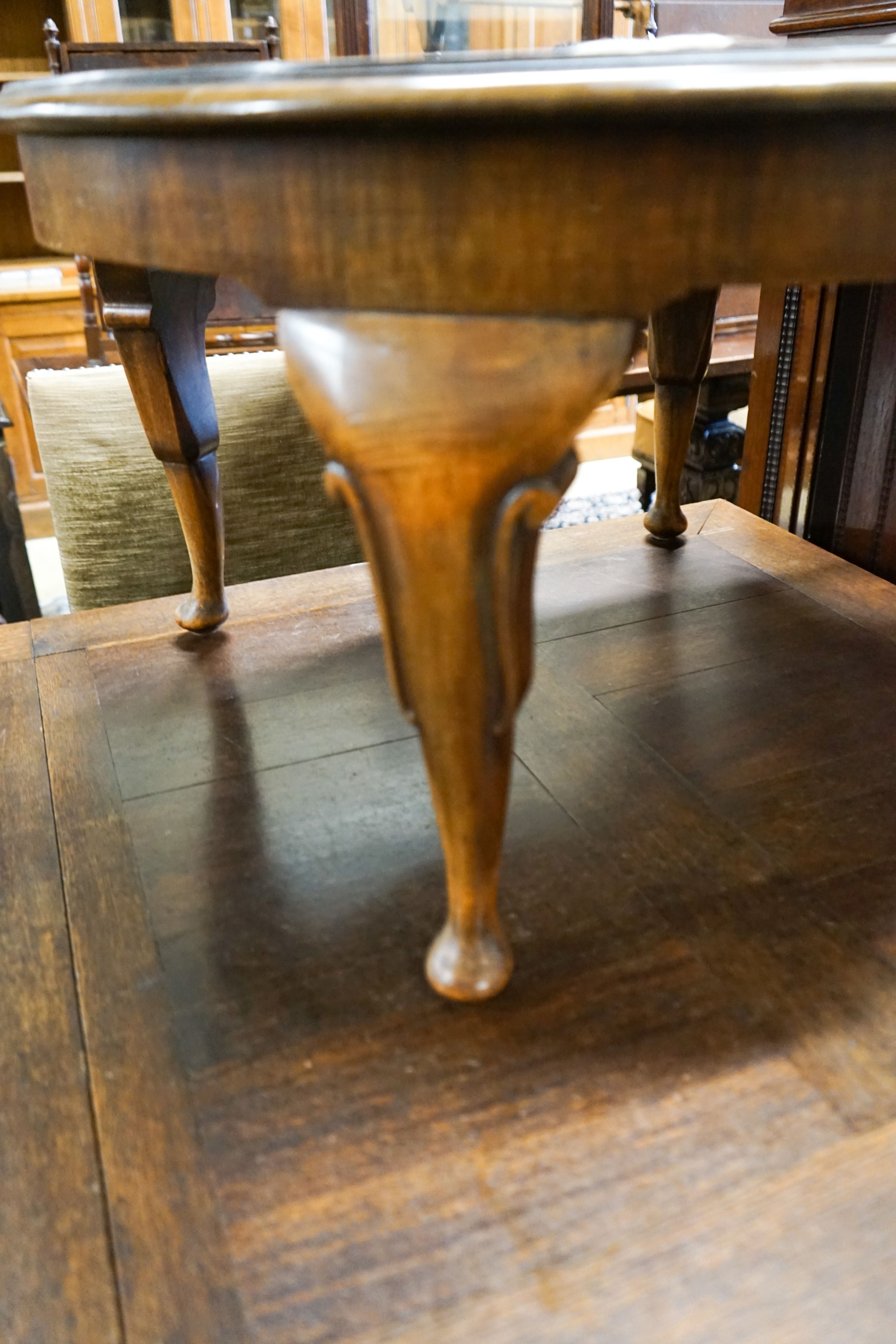 A circular burr walnut cabriole leg coffee table, diameter 84cm, height 47cm together with two Continental mahogany side tables with fretted brass galleries